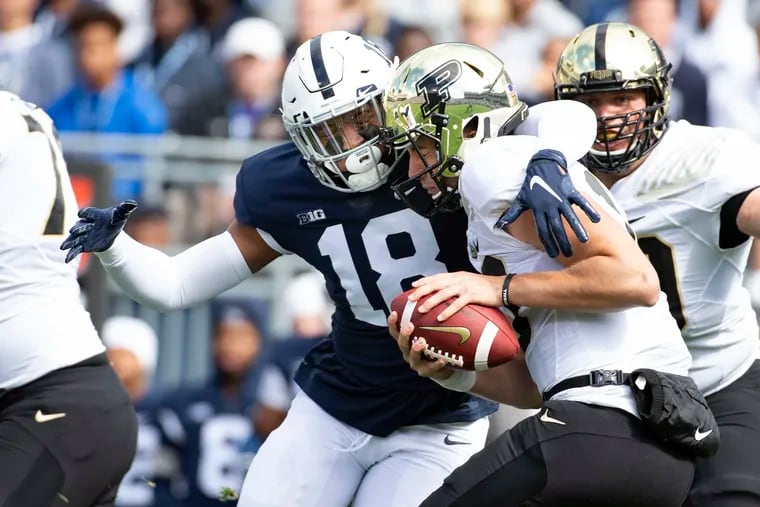 Penn State defensive end Shaka Toney (18) sacks Purdue quarterback Jack Plummer in 2019. The native of West Philadelphia and an Imhotep Charter graduate is one of eight Nittany Lions captains this season.
