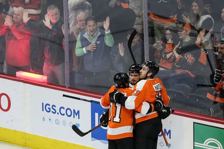Flyers center Kevin Hayes (right) celebrates his goal against the Sharks with assists from Travis Konecny (11) and Scott Laughton  during a Feb. 25 game at the Wells Fargo Center. The Flyers went 6-0 with the three players on the same line.