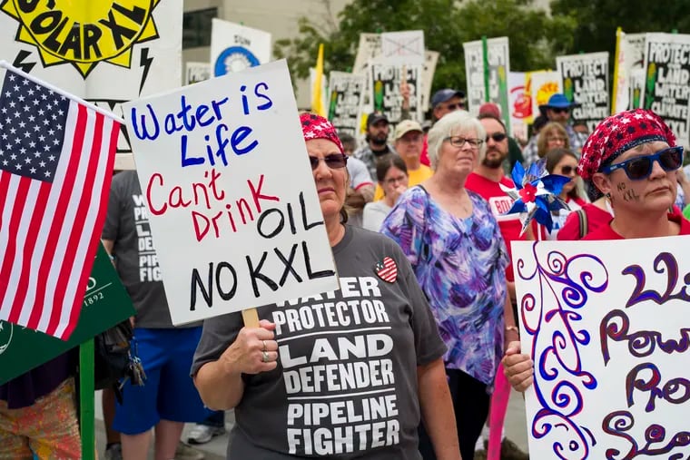 FILE - In this Aug. 6, 2017, file photo, demonstrators against the Keystone XL pipeline rally in Lincoln, Neb.