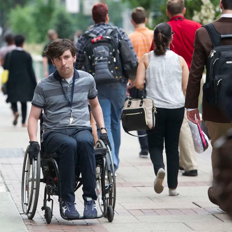 Liam Dougherty was a plaintiff in a suit accusing the city of violating federal protections for people with disabilities with inaccessible sidewalks and curb ramps. He is shown here in a 2019 file photo.