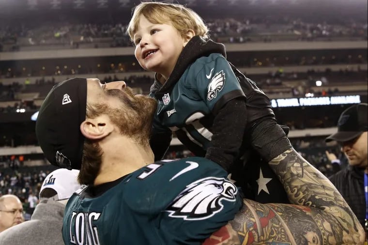 Eagles’ defensive lineman Chris Long celebrates the team’s NFC championship with his family on Sunday.