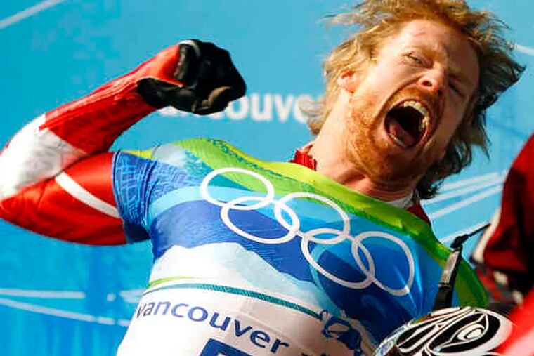Jon Montgomery celebrates his gold in the men's skeleton. After exulting over his good fortune, he apologized to the runner-up, Latvia's Martins Dukurs, for his display of emotion.