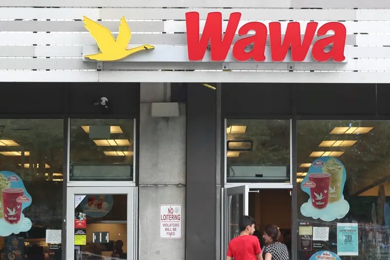 Customers enter the Wawa at 21st and Hamilton Streets in 2022.  The store is closing because its lease was not renewed. Despite Wawa's plans to expand into other states, the store would be the seventh Wawa in the city to close since 2020.