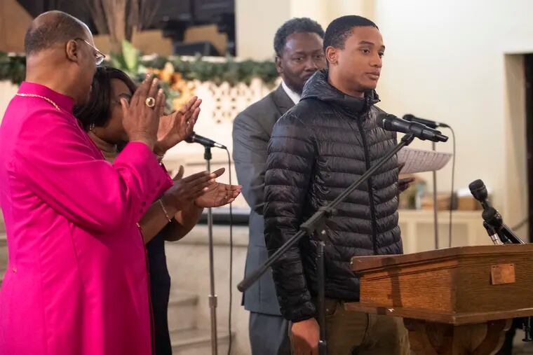 Michael White (right) stands before the congregation at the True Gospel Tabernacle Family Church in South Philadelphia on Sunday, where he took responsibility for the killing of developer Sean Schellenger  and is applauded by the Bishop Ernest McNear, left, after he thanked the church for their support through his trial.
