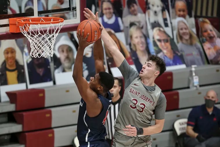 Saint Joseph's Taylor Funk tries to defend the basket from Richmond's Nathan Cayo during the teams' meeting in January.