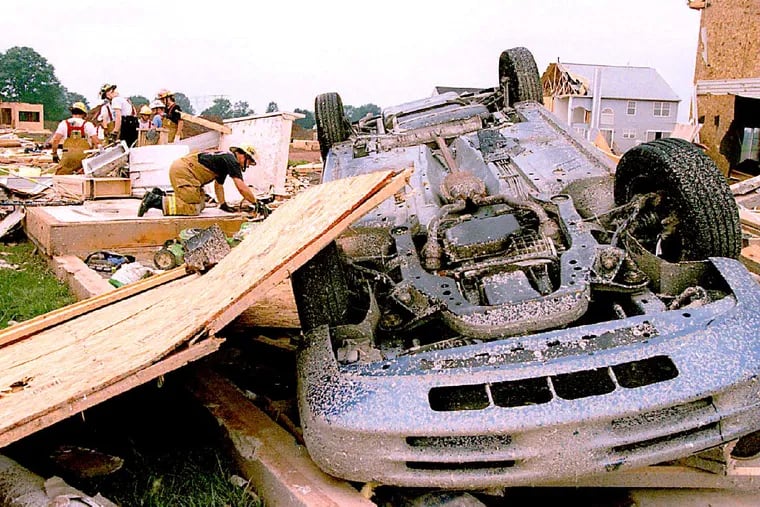 SOURCE CAPTION: Torn, Akira Suwa, City, Preg, 7/28/94; Tornado damage in Limerick Twp.;Local fire fighters are shifting through the debris of destroyed house at The Hamlet development. PHOTOGRAPHER: Akira Suwa - SHOOT DATE: Jul 27, 1994
