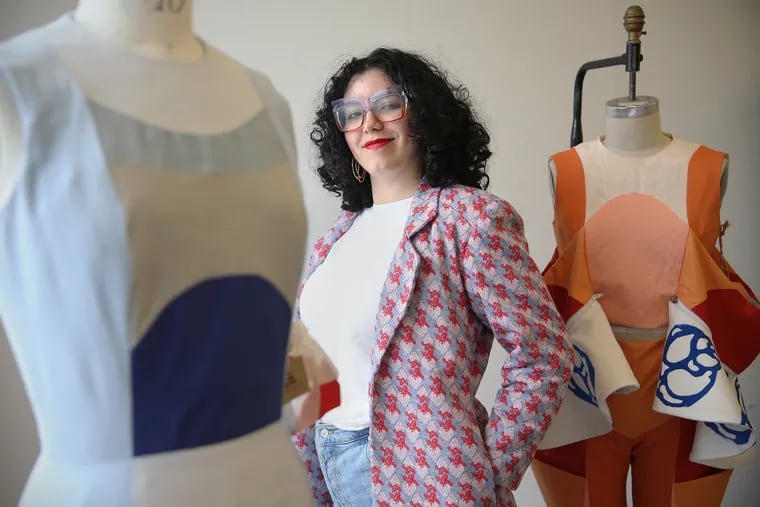 Ashleen Castillo stands for a portrait with items from her senior thesis collection, "De-transformation," at Moore College of Art and Design in Center City Philadelphia on Thursday, May 9, 2019. Castillo came to Philadelphia after her fashion design school in Puerto Rico was damaged by Hurricane Maria.