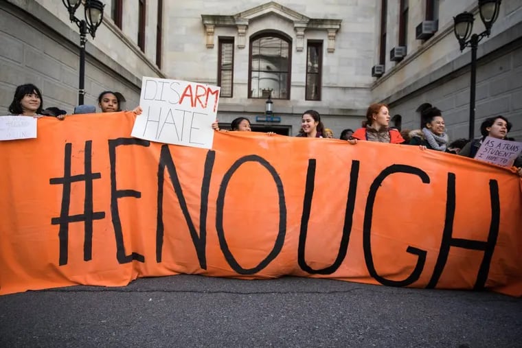 Students from Germantown Friends School hold up a banner that reads &quot;#ENOUGH&quot; during a school walkout held in the City Hall courtyard on Friday, April 20, 2018.