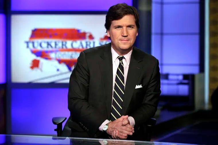 FILE - In this March 2, 2017 file photo, Tucker Carlson, host of "Tucker Carlson Tonight," poses for photos in a Fox News Channel studio, in New York. The liberal advocacy group Media Matters for America this week released two batches of recordings Carlson made as a guest on a radio show where he made denigrating remarks about race and gender. It was timed to coincide with Fox’s first-ever sales meeting with advertisers on Wednesday, March 12, 2019. Media Matters says it wants to pressure Fox into better behavior by making advertisers aware of what is being said on the air. Carlson says critics want to shut Fox down. (AP Photo/Richard Drew, File)