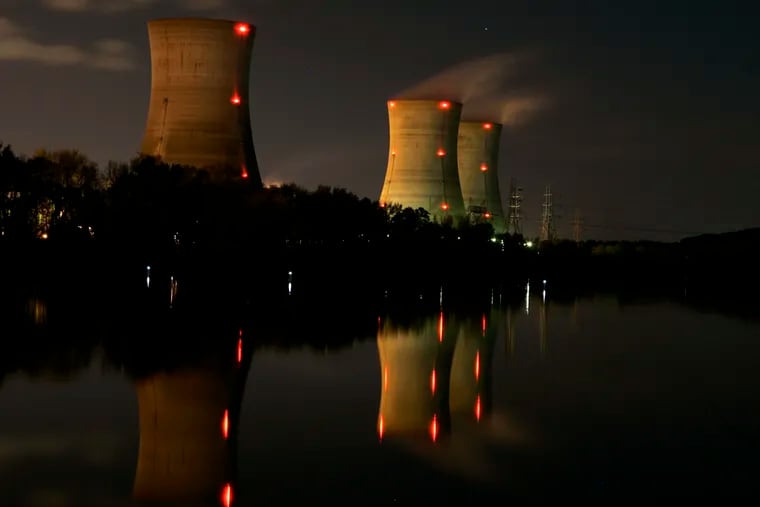 FILE photo shows cooling towers of the Three Mile Island nuclear power plant reflected in the Susquehanna River in in Middletown, Pa. Newer reactor designs are moving away from gargantuan nuclear power plants like the TMI in favor of small modular reactors with fewer parts. (AP Photo/Carolyn Kaster)