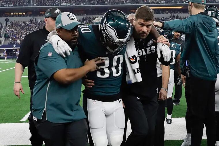 Corey Clement gets help leaving the field after injuring his leg during the Eagles' loss to Dallas on Sunday.