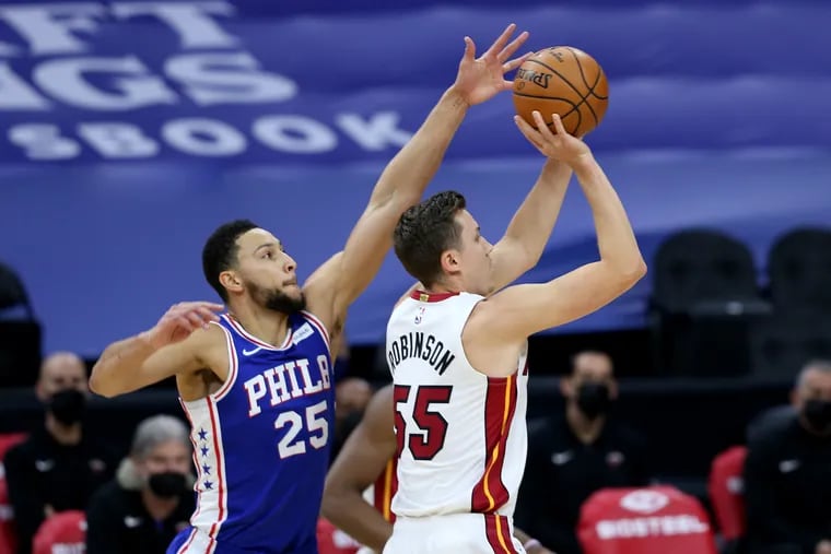 Ben Simmons comes from behind to try to block a shot by Duncan Robinson of the Heat during the first half.