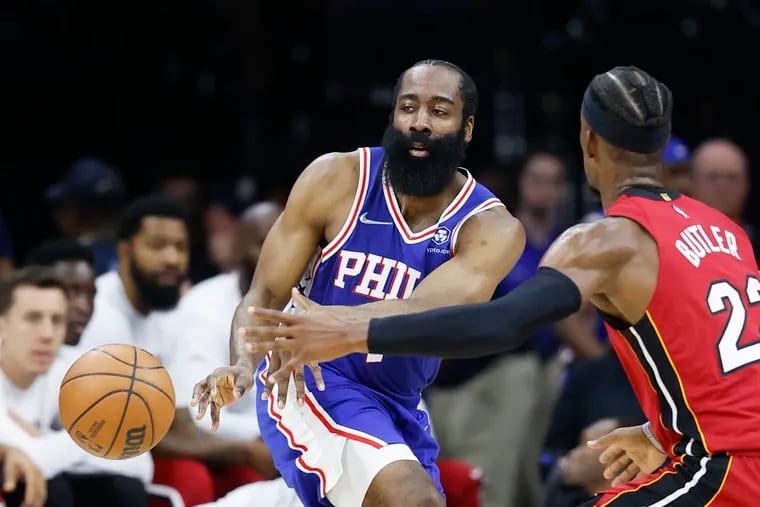 Sixers guard James Harden passes the basketball past Miami Heat forward Jimmy Butler during game six of the second-round Eastern Conference playoffs on Thursday, May 12, 2022 in Philadelphia.
