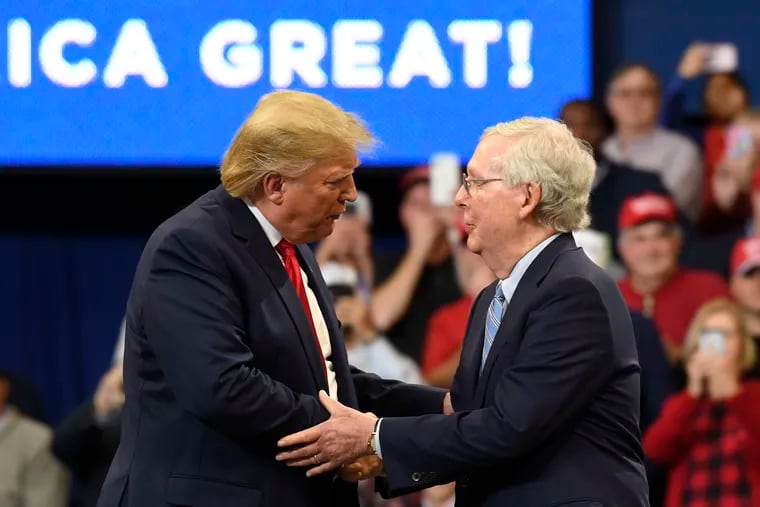 In this Nov. 4, 2019 file photo, President Donald Trump greets Senate Majority Leader Mitch McConnell of Ky., on stage during a campaign rally in Lexington, Ky. The paperback edition of McConnell’s “The Long Game” includes a foreword from Trump. In the foreword, Trump praises the Kentucky Republican as an ideal partner in confirming conservative judges, notably Supreme Court Justices Neil Gorsuch and Brett Kavanaugh.