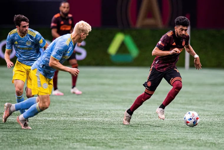 Atlanta United's Marcelino Moreno, right, on the ball in front of the Union's Jakob Glesnes, center, and Leon Flach, left, during Sunday's game.