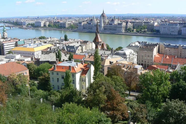 A view of Budapest from the Buda side. The Danube divides the city into Buda and its old city on the west and the commercial district of Pest on the east. Once, only a ferry connected the sides; now, the elegant Chain Bridge is among the crossings.