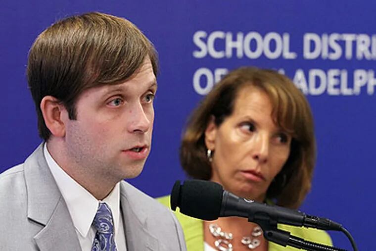 Daniel Piotrowski, executive director of Accountability and Assessment (left), and Francis Newburg, deputy chief of Accountability and Educational Technology (right), answer questions from the media after a press conference to release the Philadelphia School District's findings about test cheating in their schools. (Michael Bryant / Staff photographer)