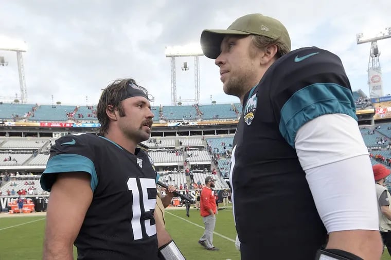 Jacksonville Jaguars quarterbacks Gardner Minshew (left) and Nick Foles talk on the field following their loss to the Tampa Bay Buccaneers on Sunday.