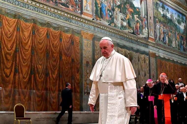 Pope Francis walks after posing for photographs with members of the Diplomatic Corps accredited to the Holy See, inside the Sistine Chapel inside the Sistine Chapel, at the Vatican, Monday, Jan. 7, 2019.