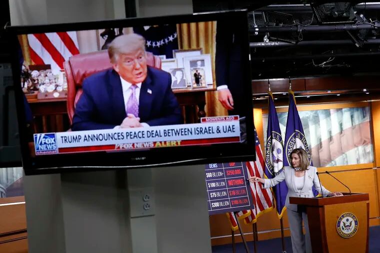 House Speaker Nancy Pelosi speaks during a news conference on Capitol Hill, as a television broadcasts President Donald Trump speaking from the White House.