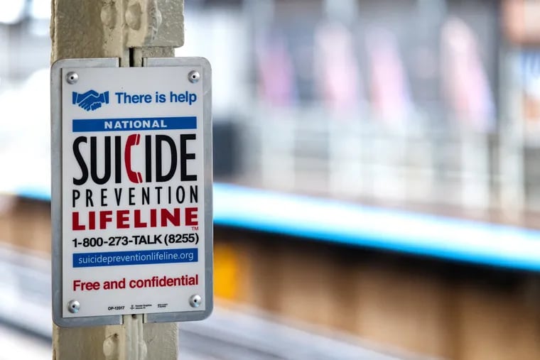 A suicide prevention sign in a subway station in Chicago.
