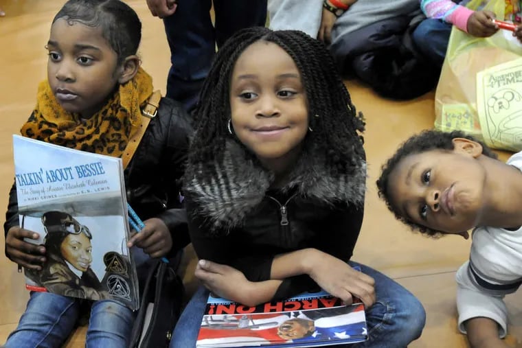 Good story: (from left) Zaheera Miller, 5; Naimah Harris, 6; and Jaden Gray, 4, take in a presentation at the African American Children's Book Fair in Philadelphia.