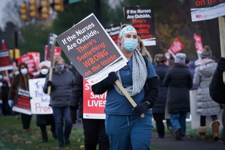 Stacy Cipollone, on strike along with other registered nurses, protests outside St. Mary Medical Center in Langhorne on Tuesday.