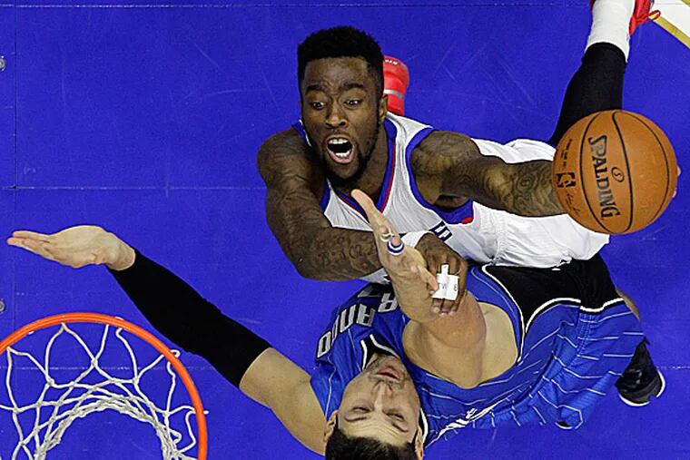 The 76ers' Tony Wroten goes up for a shot against the Magic's Nikola Vucevic during the second half. (Matt Slocum/AP)
