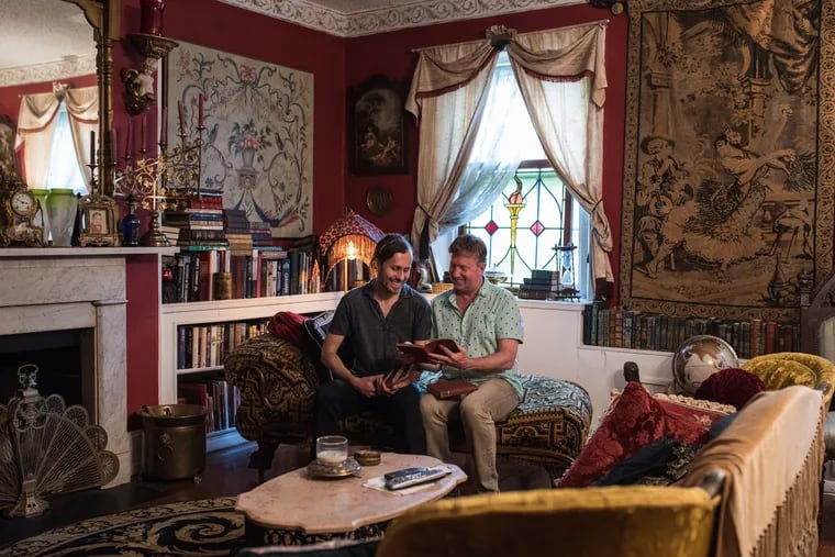 Avid antique enthusiasts, Carl Engelke and Markus Aman sit in their living room paging through some of the family heirlooms they unexpectedly stumbled upon in the Jinxed in Fishtown.