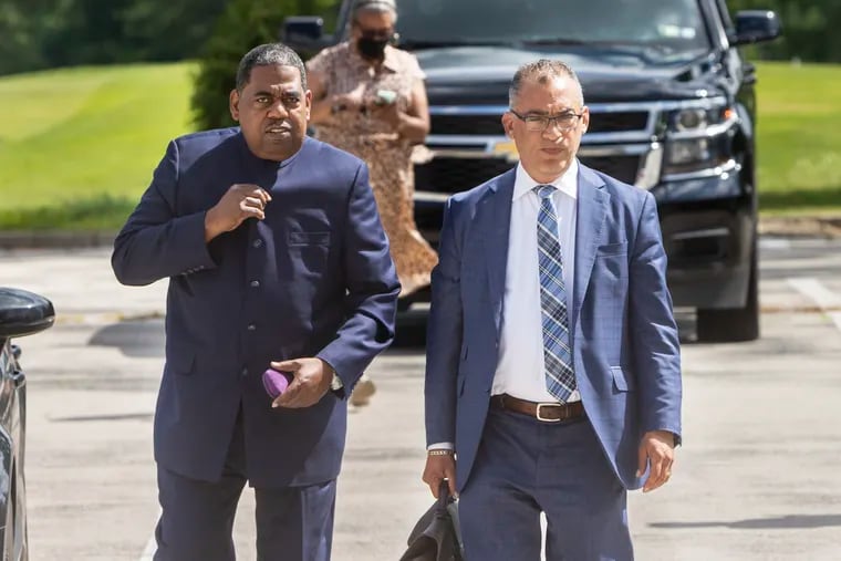 Rev. Mark Hatcher (left), the pastor at Holy Ghost Headquarters, arrives to a preliminary hearing in Blue Bell on Thursday with his defense attorney Robert Gamburg. Hatcher has been charged with sexually assaulting three people, including a former parishioner, when they were children.
