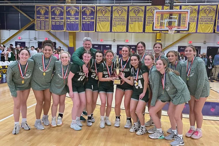 The Bishop Shanahan girls' basketball team poses together after winning the District 1 5A championship on Wednesday at West Chester.