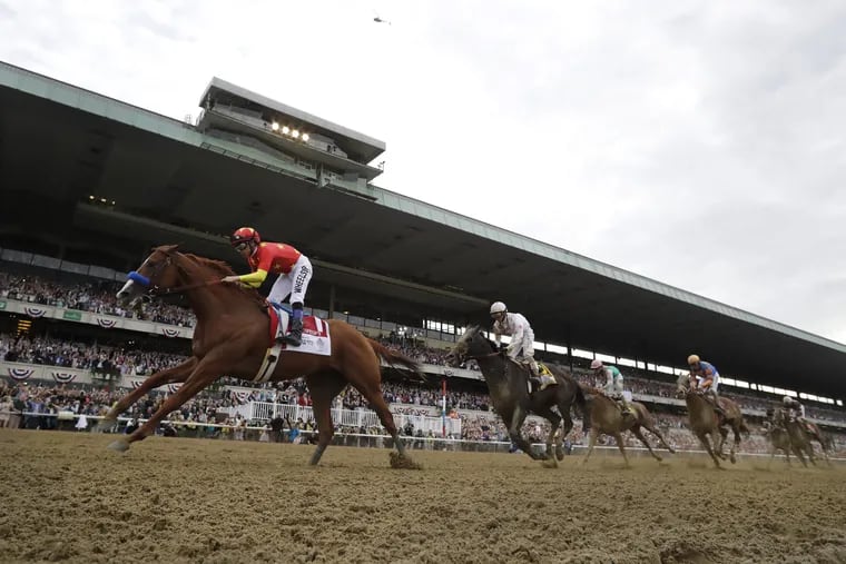 Justify, with jockey Mike Smith, became just the second unbeaten horse to win a Triple Crown with Saturday's first-place finish in the Belmont Stakes.