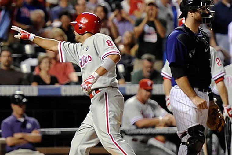 Shane Victorino points at his family in the stands as he celebrates his 10th-inning home run. (Chris Schneider/AP)