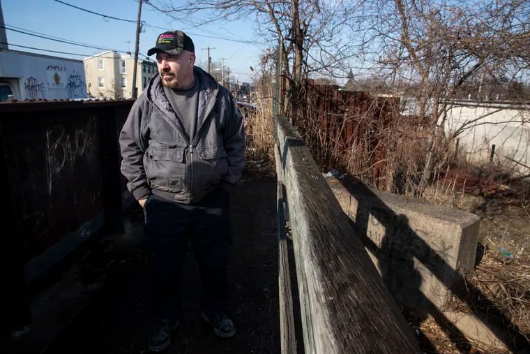 Bill Janes, owner of 63rd Street Automotive at 63rd and Greenway Streets, talks about the Cemetery Avenue bridge in Philadelphia, Pa. on Tuesday, February 8, 2022. The deteriorated Cemetery Avenue bridge crosses a CSX railroad.