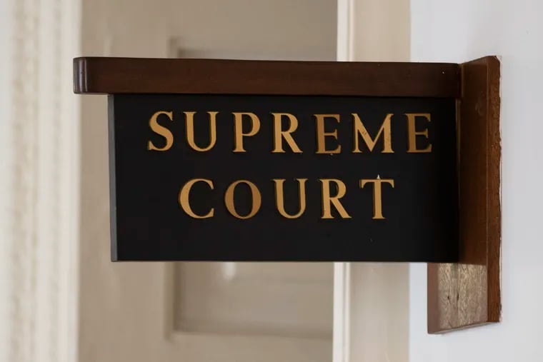 The sign for the Pennsylvania Supreme Court is posted by its door at City Hall in Philadelphia, Wednesday, Sept. 11, 2019. The Pennsylvania Supreme Court is set to consider whether the death penalty amounts to cruel, arbitrary punishment that's too often reserved for black and poor defendants. (AP Photo/Matt Rourke)