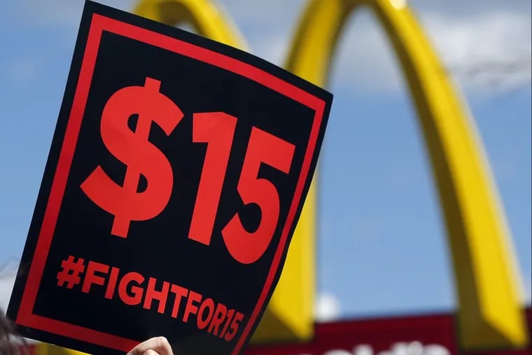 FILE–In this July 22, 2015 file photo, supporters of a $15 minimum wage for fast food workers rally in front of a McDonald's in Albany, N.Y. Millions of workers across the U.S. will see their pay increase as 19 states bump up their minimum wages as the new year begins. California, New York and Arizona are among the states with increases taking effect Saturday or Sunday. New York state is taking a regional approach, with the wage rising to $11 in New York City, $10 in its suburbs and $9.70 upstate. (AP Photo/Mike Groll, File)