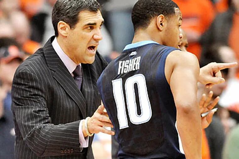 Jay Wright watched his players hit big threes and key free throws in Saturday's win at Syracuse. (Kevin Rivoli/AP)