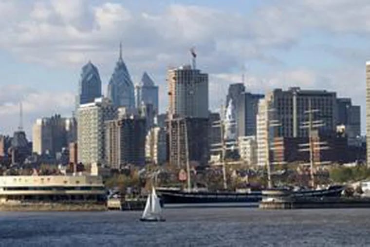 Philadelphia's skyline, seen from Camden. Despite economic mixed signals, construction has boomed, with riverside condos and Comcast's tower in Center City.
