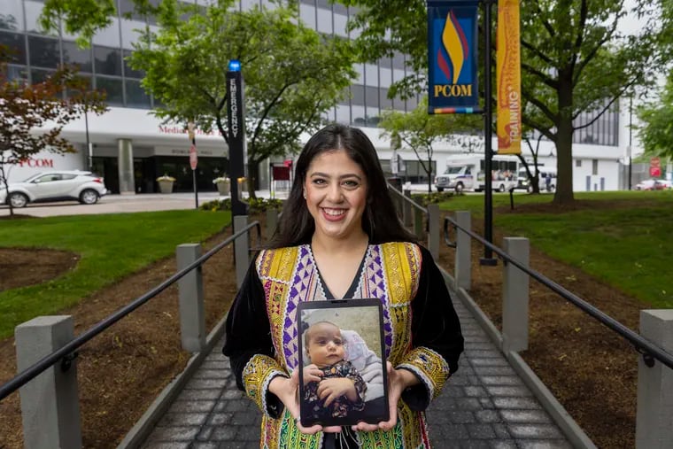 Selli Abdali is a medical student at Philadelphia College of Osteopathic Medicine. She's Afghan by heritage and speaks Pashto, so when Afghan evacuees began arriving at the Philadelphia airport in August, she immediately went to help. A family she helped named their new baby after her, both seen here in a photograph taken at PCOM on Friday morning May 27, 2022.