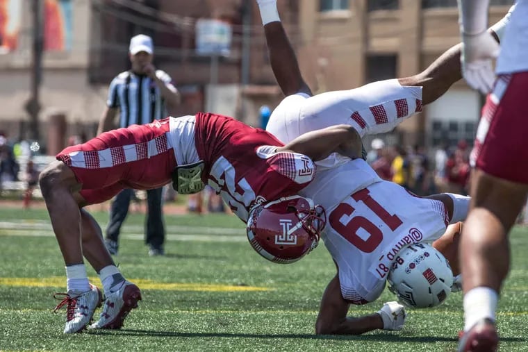 Cornerback Rock Ya-Sin (left) picks up wide receiver Ventell Bryant and throws him to the ground during Temple's Cherry and White spring football game at the Temple Sports Complex Saturday, April 14, 2018.