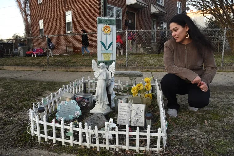 Angela Medina Trader with the memorial she maintains at the place in the Fairview neighborhood in Camden where her son, Troy Anderson, was shot and killed in 2014. She says she prefers it to his tombstone because it gives her a happy feeling. "It's a memorial to say he was here, he existed," says Trader.