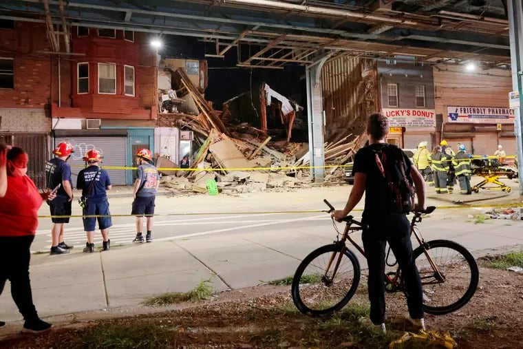 Firefighters at the scene of a building collapse in the 2200 block of North Front St. in Philadelphia on Sept. 2.