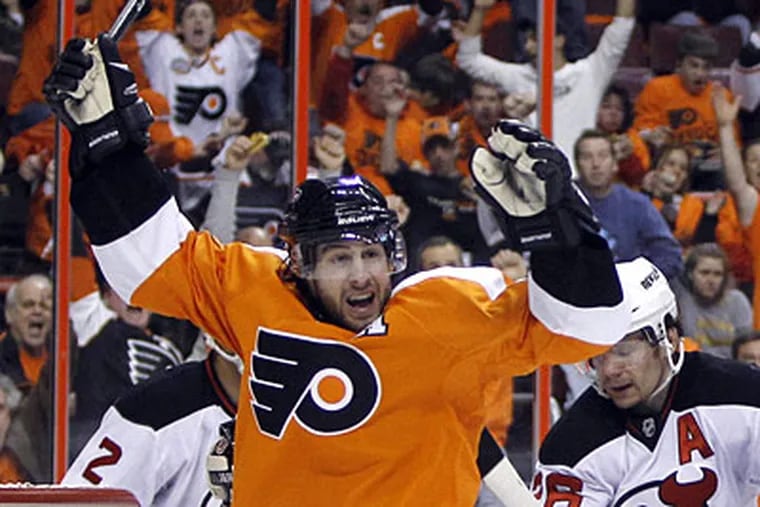 Simon Gagne celebrates a goal by teammate Mike Richards against the Devils' Martin Brodeur in Game 3 Sunday. (AP Photo/Matt Slocum)