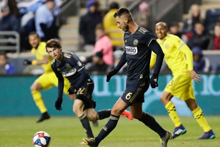 Union midfielder Haris Medunjanin kicks the soccer ball with teammate midfielder Brenden Aaronson against the Columbus Crew in MLS action on Saturday, March 23, 2019 in Chester, Pa.