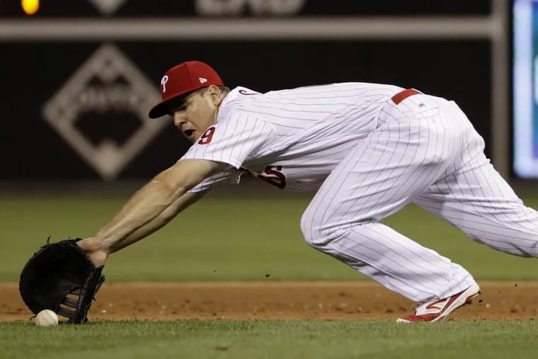 Phillies first baseman Tommy Joseph dives for a grounder.