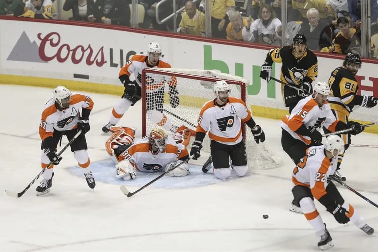 The whole Flyers team helped goalie Michal Neuvirth stop the puck against the Penguins late in the third period Friday. The Flyers staved off elimination with a 4-2 win in Pittsburgh.