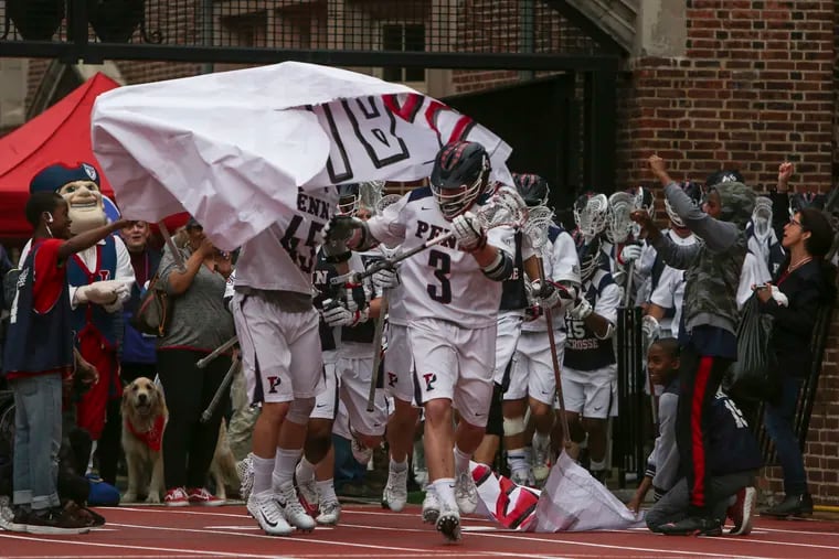 The Penn men's lacrosse team runs out on to the field before a game against Dartmouth last month.