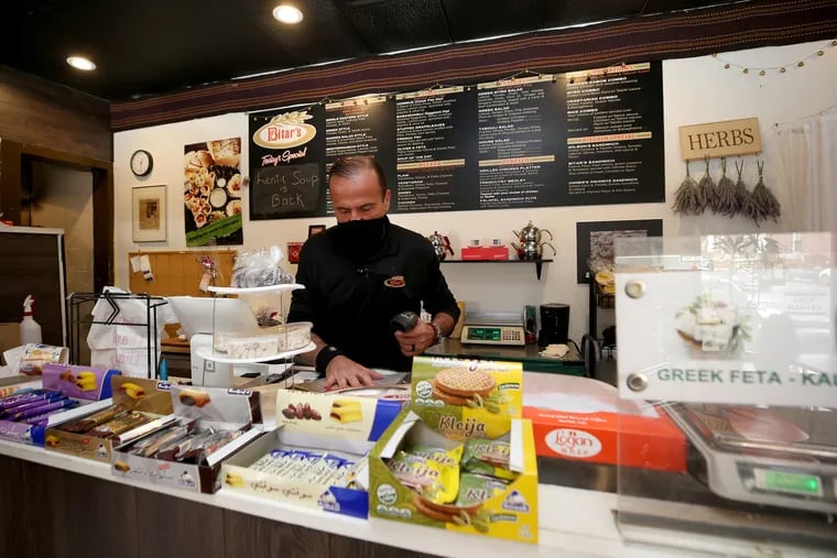 Amin Bitar fills an order at his shop, Bitar’s, in South Philadelphia. Bitar's has eight "restaurants" operating out of one kitchen.