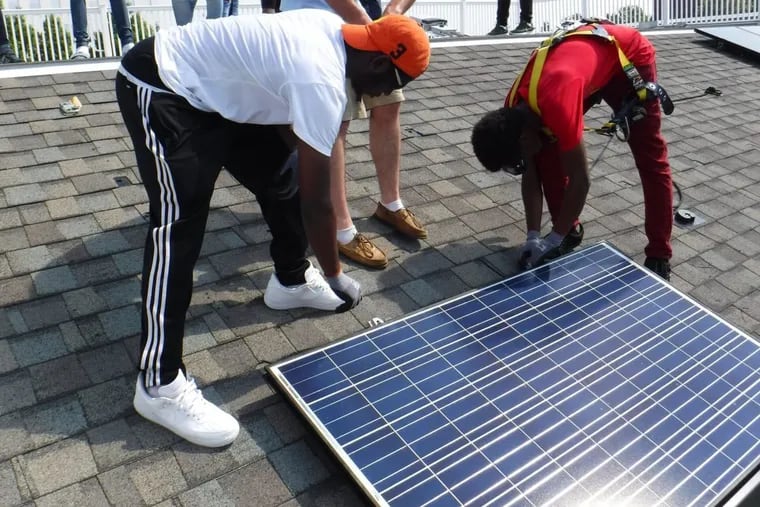 Students from the Philadelphia School District's first solar training program during the summer of 2017. Here, they are learning installation at the Navy Yard.