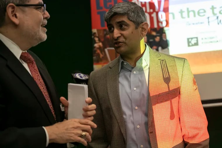 Pedro Ramos, CEO of the Philadelphia Foundation (left), speaks with Anuj Gupta, then-manager of Reading Terminal Market, before the start of a press conference announcing On the Table Philly 2019 at Reading Terminal Market on Friday, Sept. 6, 2019. This was the third consecutive year that the Philadelphia Foundation and the John S. and James L. Knight Foundation partnered to engage residents through table discussions.